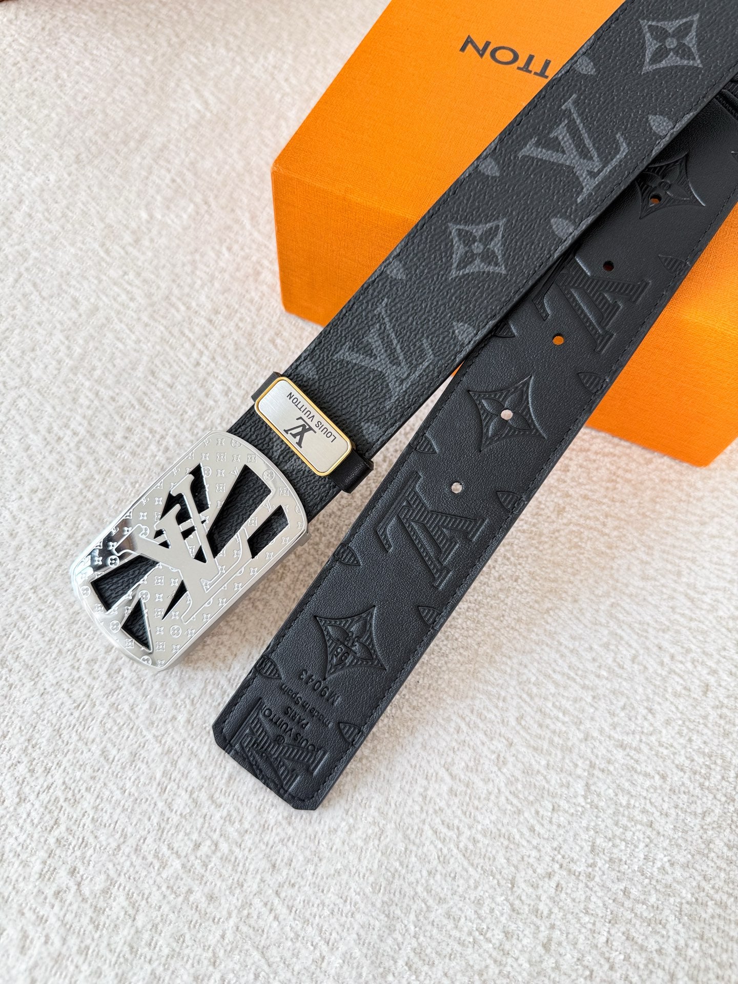 A black leather belt with monogram pattern and an intricate silver-tone buckle, 3.8cm wide.