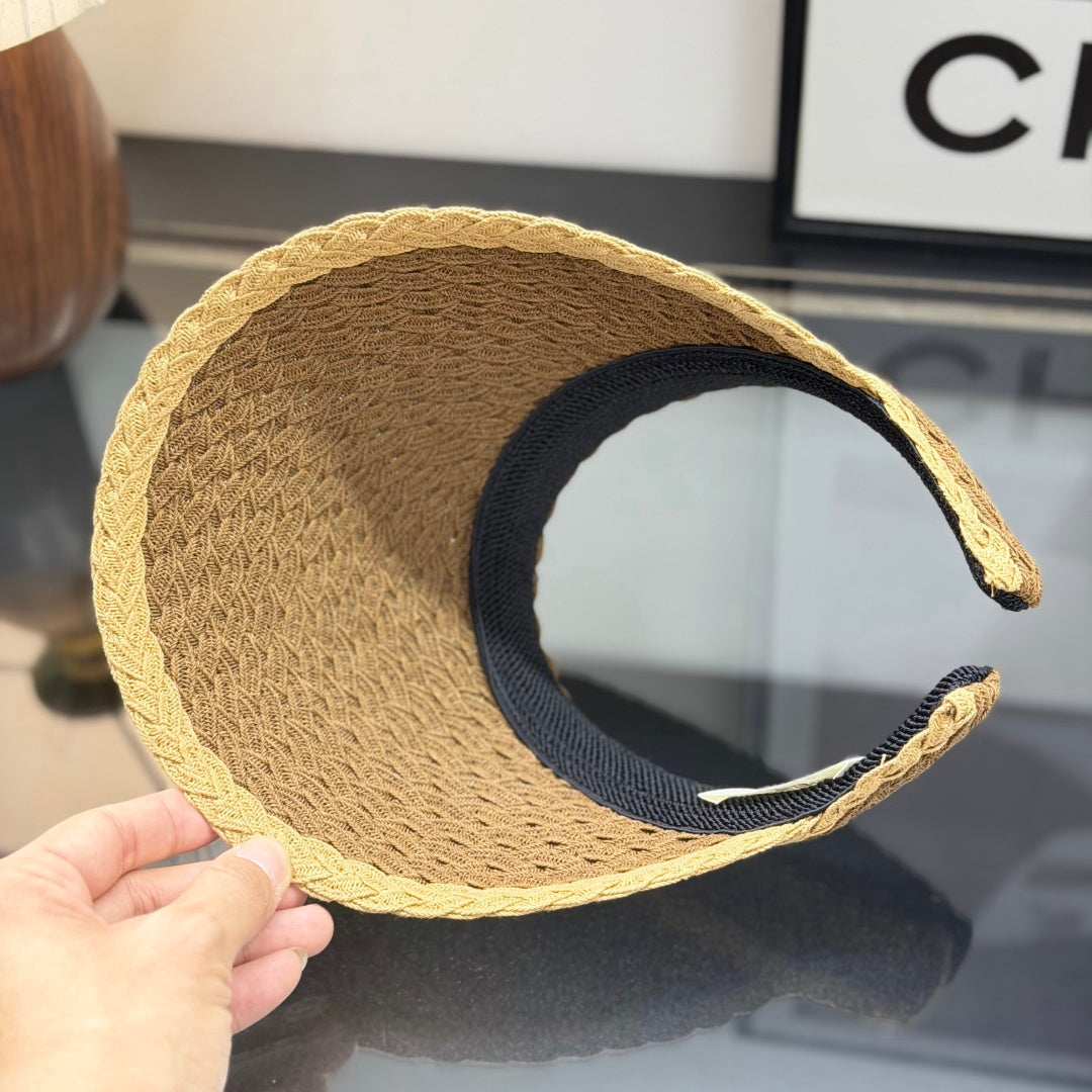 A stylish, high-quality woven straw visor hat with a decorative emblem, perfect for summer sun prote