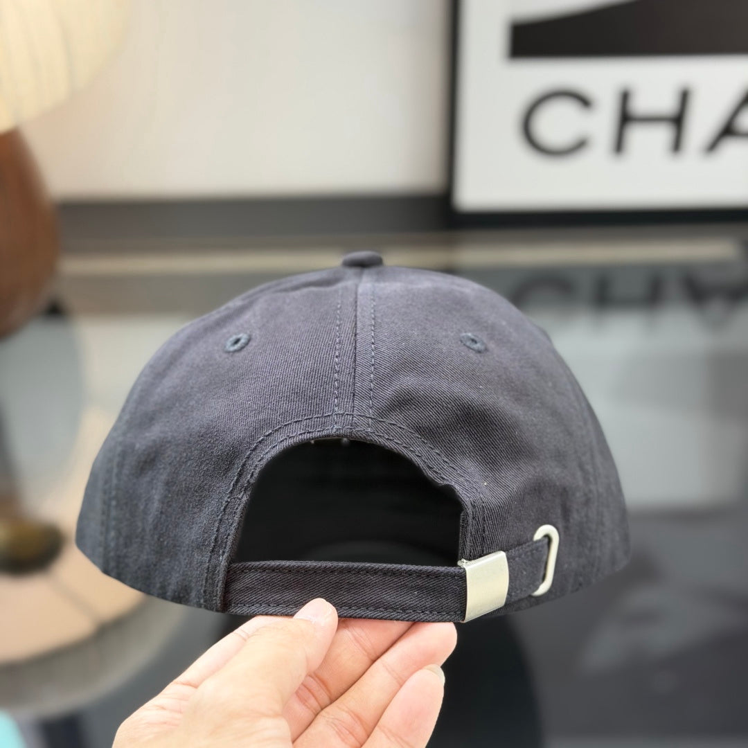 A structured black cotton baseball cap with a rectangular tan faux-leather patch on the front.