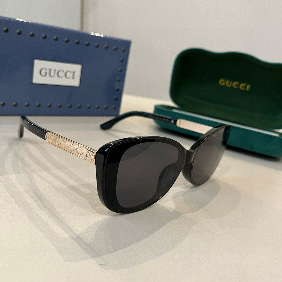 Elegante schwarze Cat-Eye-Sonnenbrille mit GG-Muster