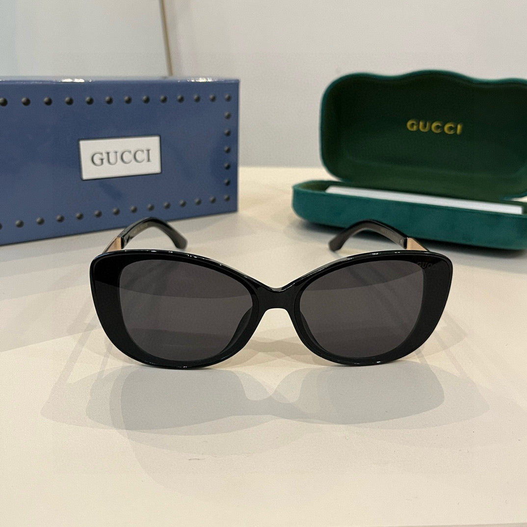 Elegante schwarze Cat-Eye-Sonnenbrille mit GG-Muster