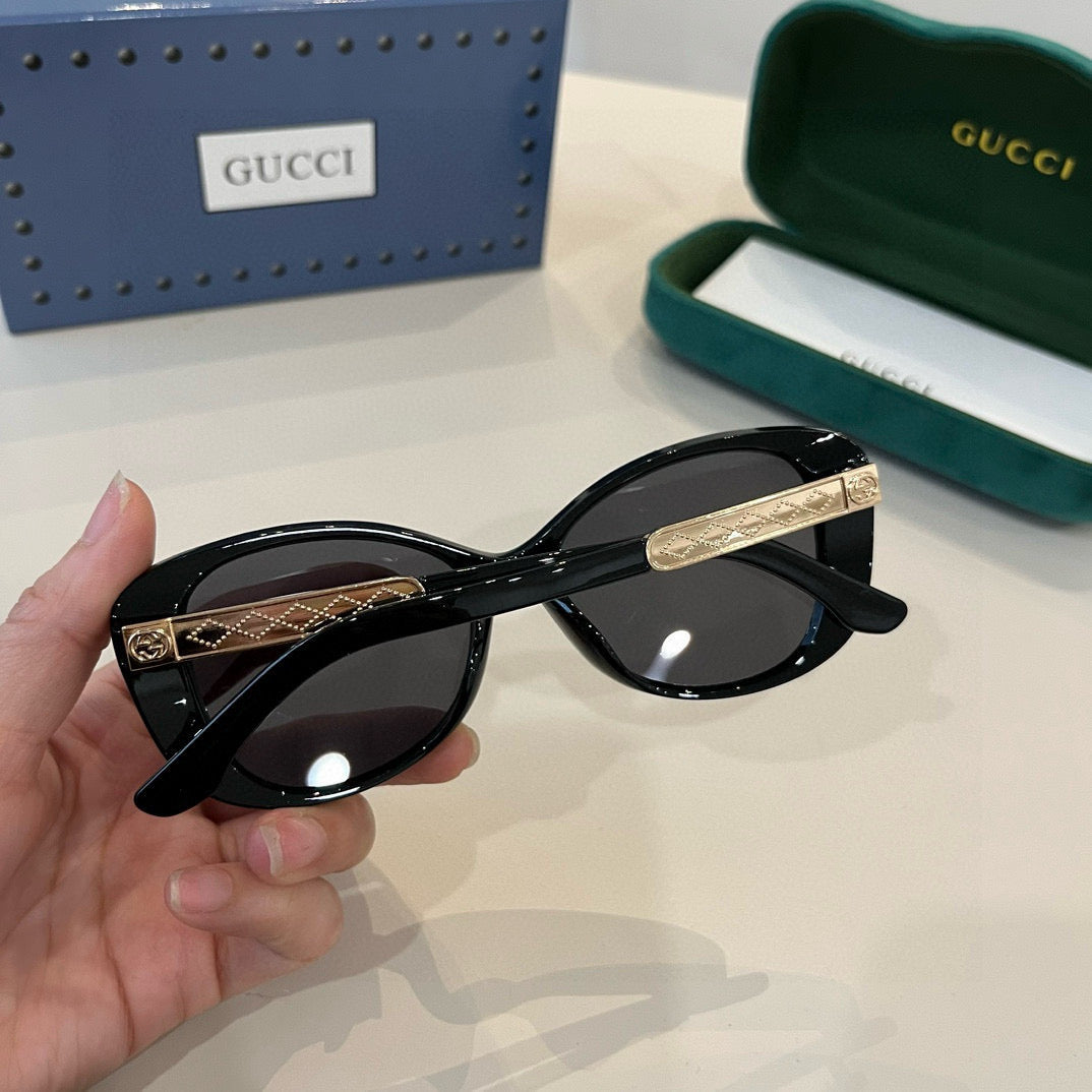 Elegante schwarze Cat-Eye-Sonnenbrille mit GG-Muster