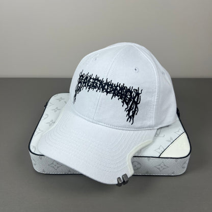 White cotton cap with black graphic embroidery and sculpted brim