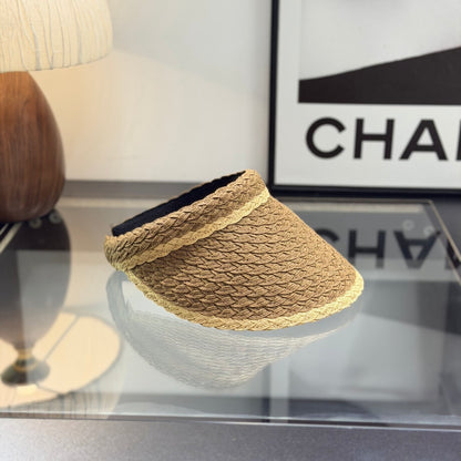 A stylish, high-quality woven straw visor hat with a decorative emblem, perfect for summer sun prote