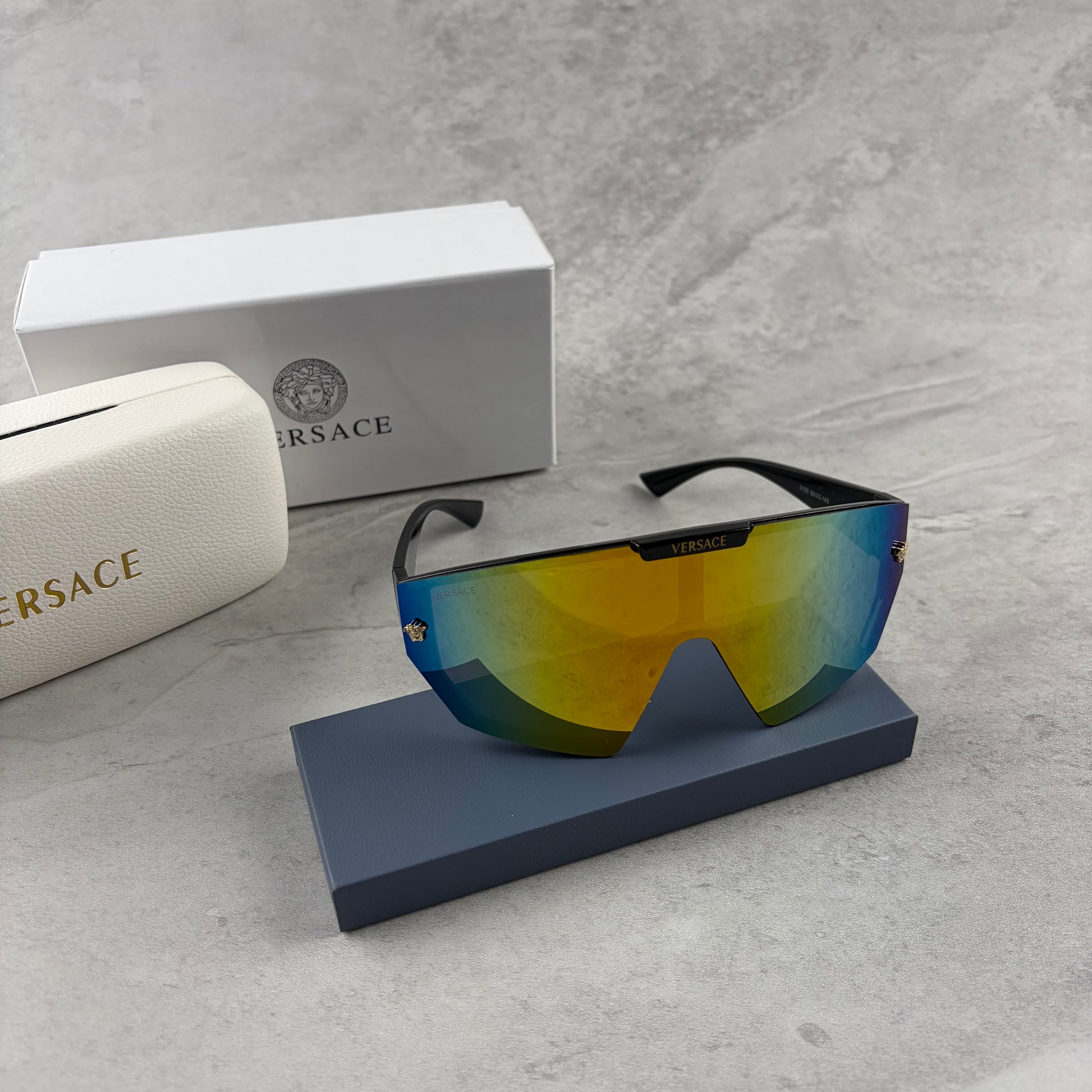 Modern shield-style visor sunglasses with wide black frames and vibrant gradient mirror lenses.