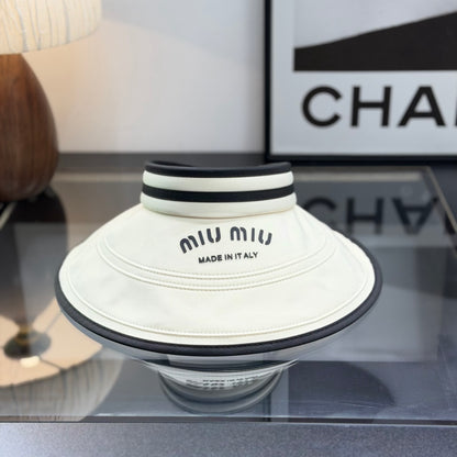 A stylish off-white open-top sports visor with black trim and embroidered text detailing.