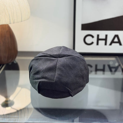 Close-up of a premium dark grey textured ivy cap with a white embroidered logo, high-quality fabric.