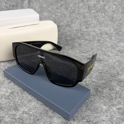 Oversized black shield sunglasses with a clean, modern aesthetic and protective hard storage case.