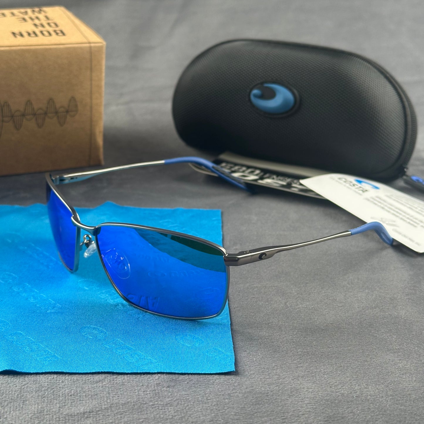 Close-up of performance polarized sunglasses with blue mirror lenses and lightweight metal frame.