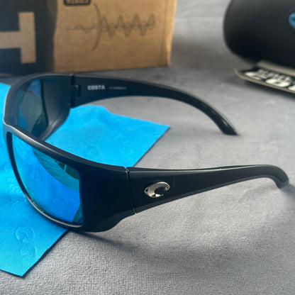 Matte black frame sport sunglasses with blue mirror lenses, including a protective case and cloth.