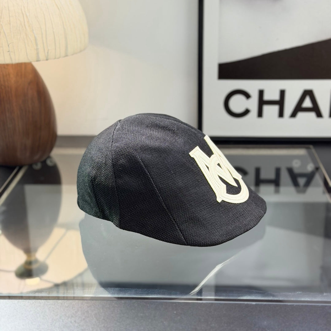 Close-up of a premium dark grey textured ivy cap with a white embroidered logo, high-quality fabric.