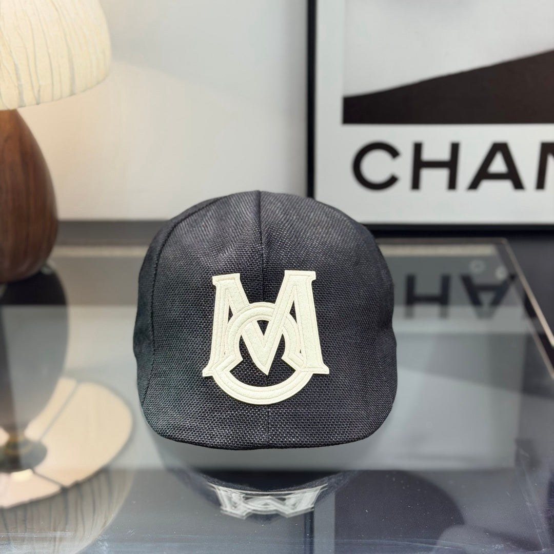 Close-up of a premium dark grey textured ivy cap with a white embroidered logo, high-quality fabric.
