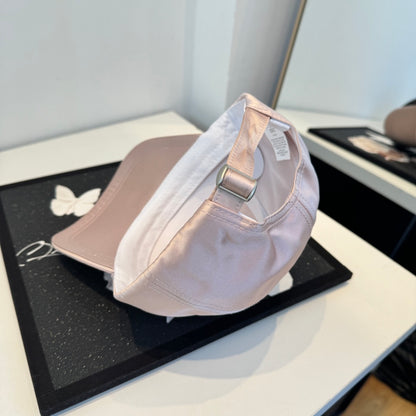Dusty pink satin baseball cap with a curved brim, featuring a minimalist adjustable back strap.