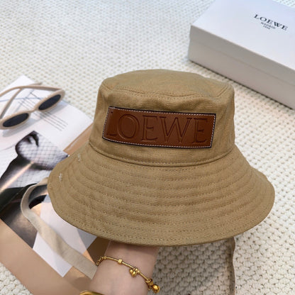 Soft canvas bucket hat with embossed leather logo patch and adjustable chin strap