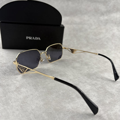 Geometric metal-frame sunglasses in gold tone with dark smoke lenses and signature triangular temple