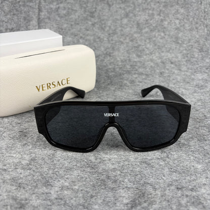 Oversized black shield sunglasses with a clean, modern aesthetic and protective hard storage case.