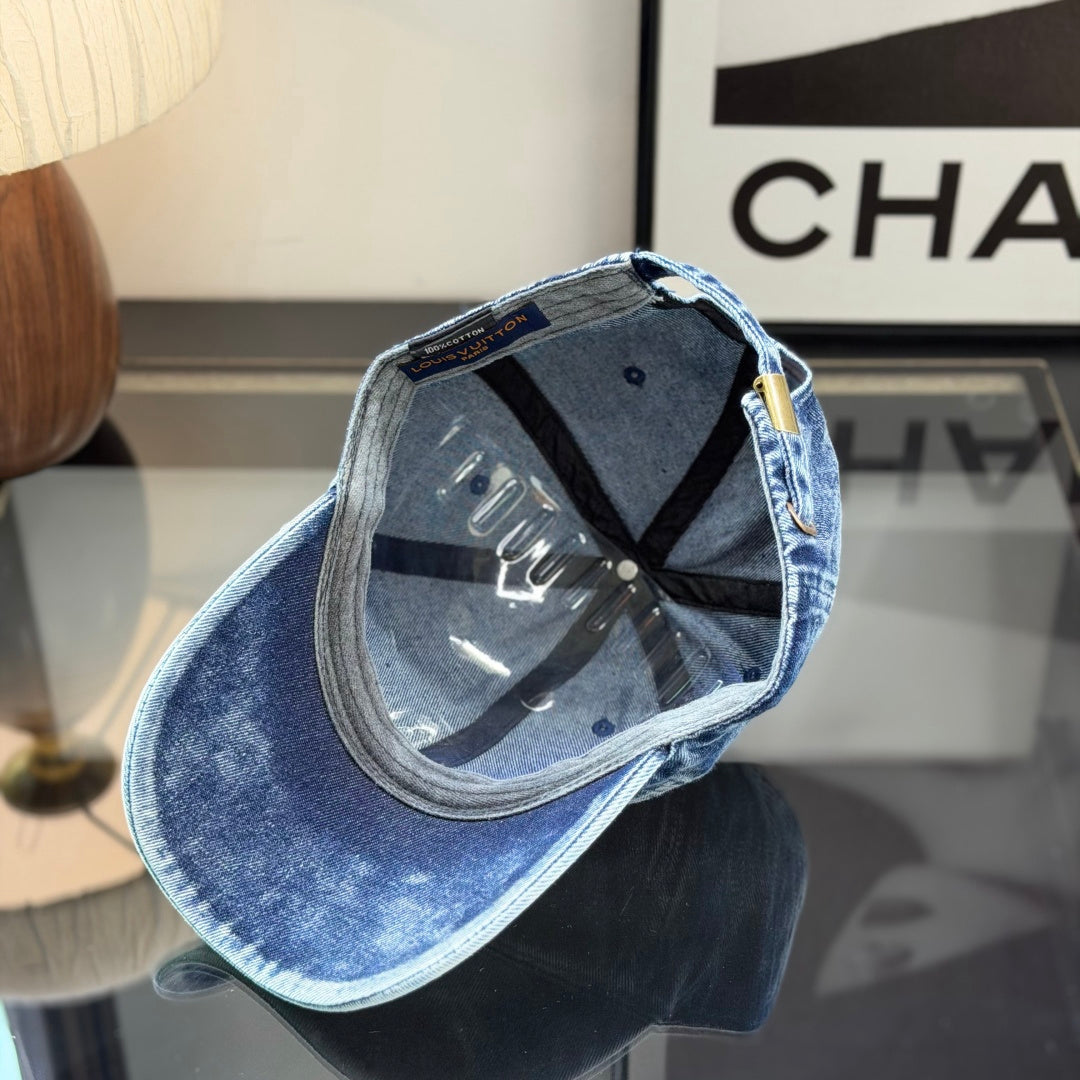 A vintage acid-washed denim baseball cap with embroidered logo detail, styled for a casual look.