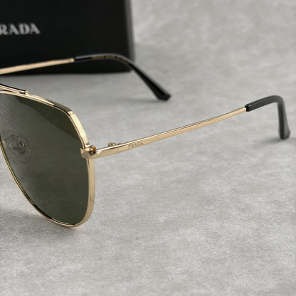 Classic gold-tone metal aviator sunglasses with tinted lenses, resting next to a protective case.
