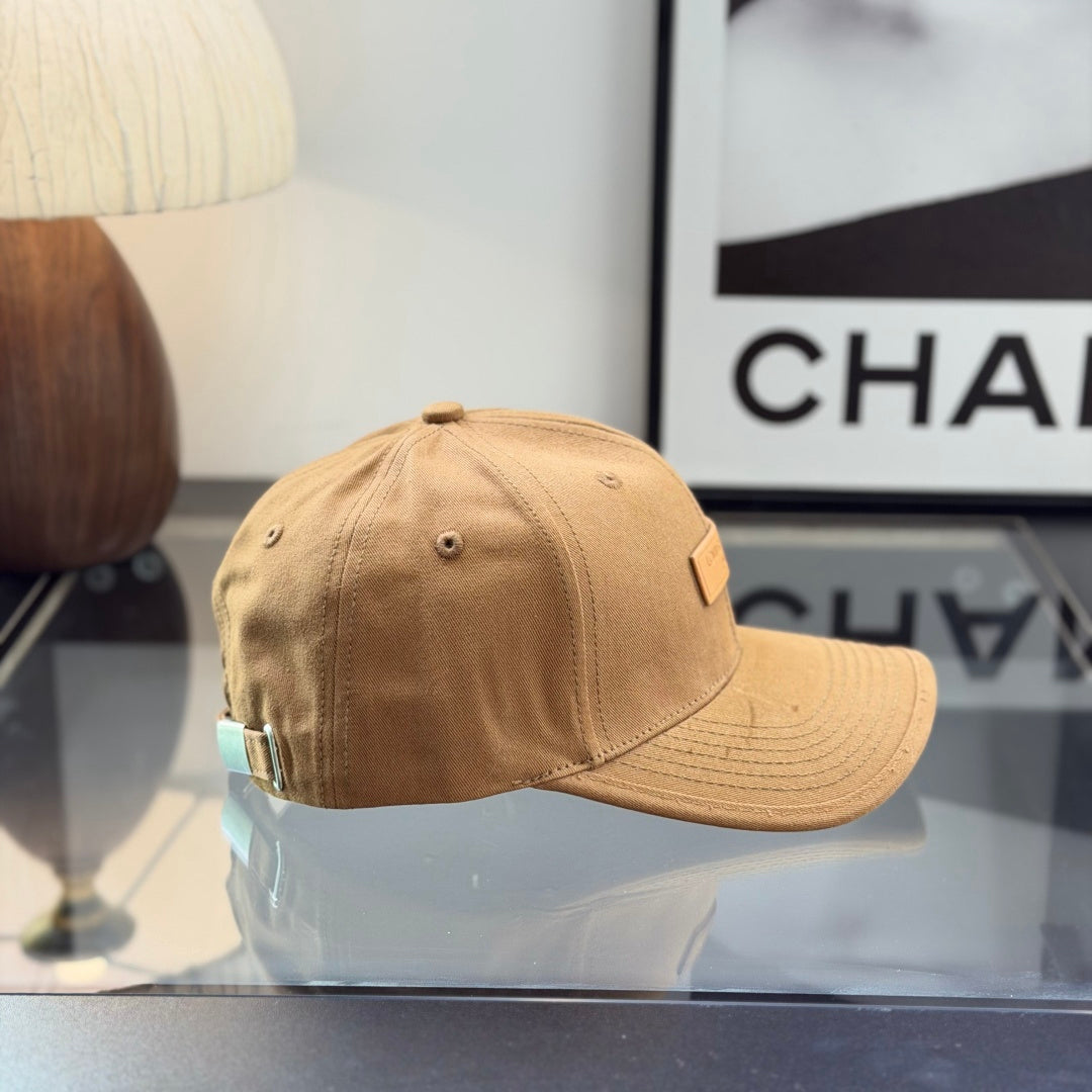 A premium camel-colored cotton baseball cap with a structured crown and an embossed leather patch.