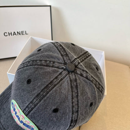 Black vintage-washed denim baseball cap featuring a colorful embroidered circular front patch.