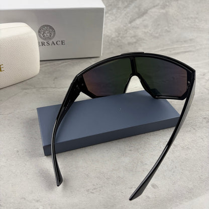Modern shield-style visor sunglasses with wide black frames and vibrant gradient mirror lenses.