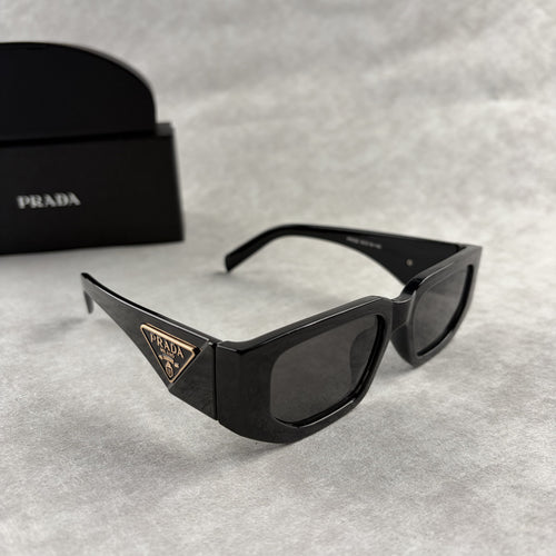 Modern black rectangular sunglasses with dark lenses and thick frame, isolated on a light background