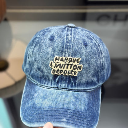 A vintage acid-washed denim baseball cap with embroidered logo detail, styled for a casual look.