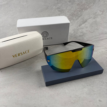 Modern shield-style visor sunglasses with wide black frames and vibrant gradient mirror lenses.