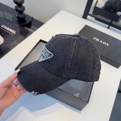 A black distressed denim baseball cap with a sparkling triangular patch on the front center.
