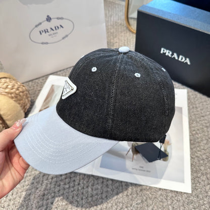 A two-tone denim baseball cap featuring a white triangle emblem patch on the front, neutral brim.