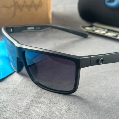 Matte black sport sunglasses with polarized blue-tinted lenses, hard case, and cleaning cloth.