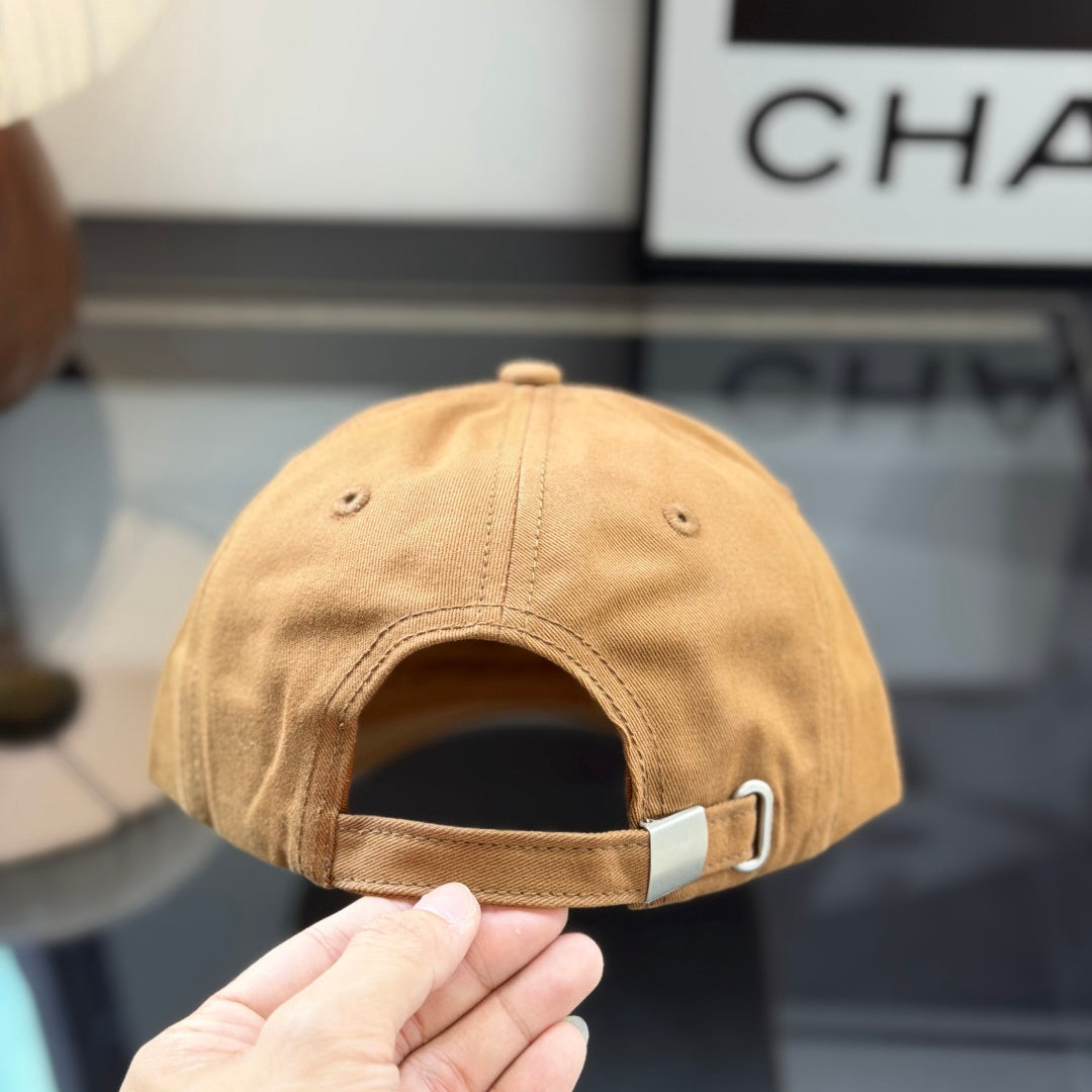 A premium camel-colored cotton baseball cap with a structured crown and an embossed leather patch.