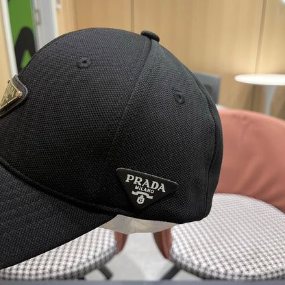 A black premium structured baseball cap with a centered metal triangular emblem on the front.