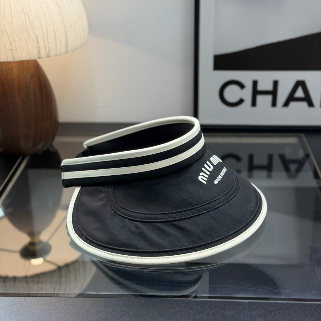 A black sun visor with white contrast trim, featuring an open-top design for breathability and sun p