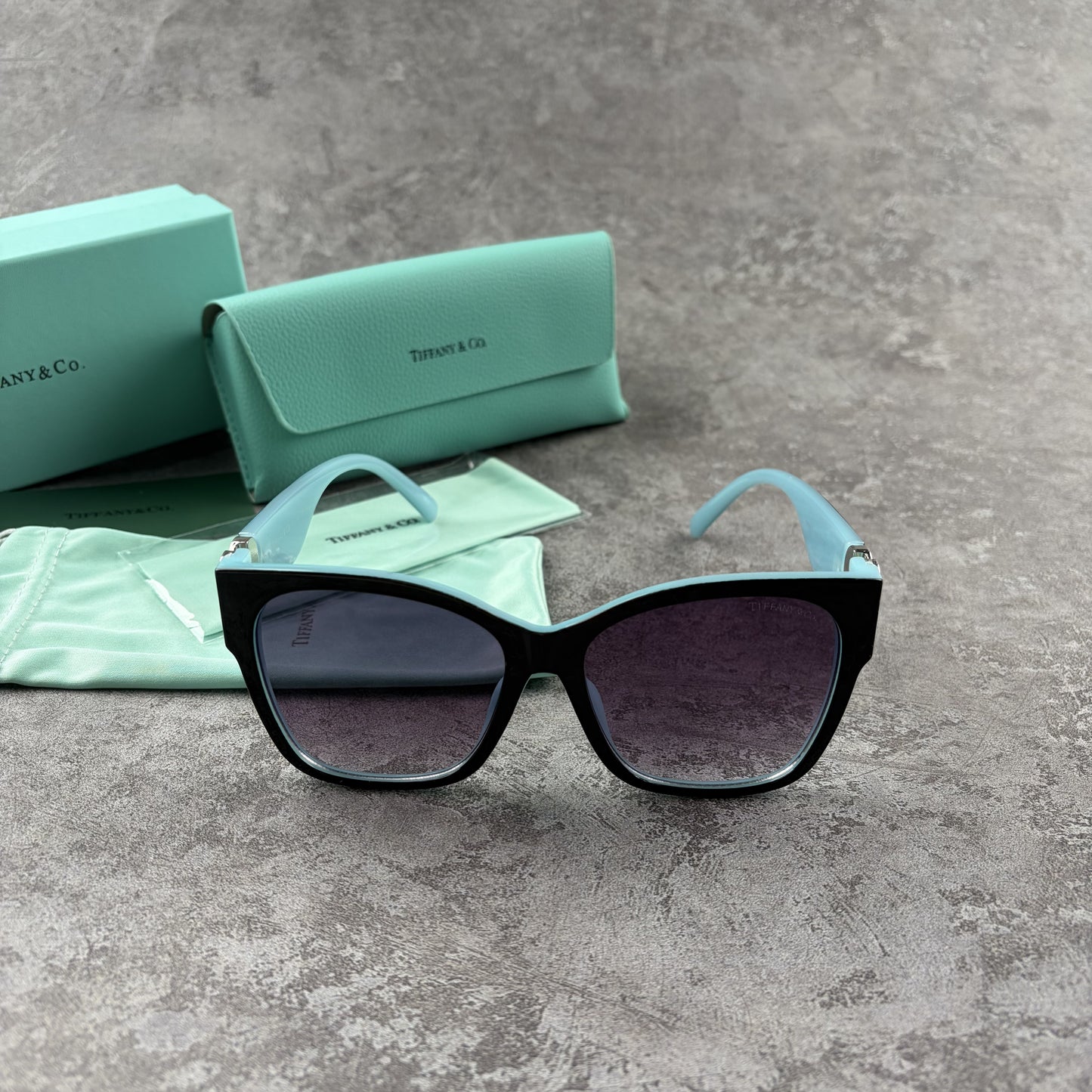 Stylish cat-eye sunglasses with gradient lenses and heart-shaped silver side details.