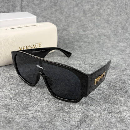 Oversized black shield sunglasses with a clean, modern aesthetic and protective hard storage case.