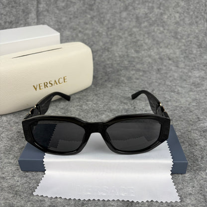 Classic black rectangular frame sunglasses featuring decorative gold-tone metallic side accents.