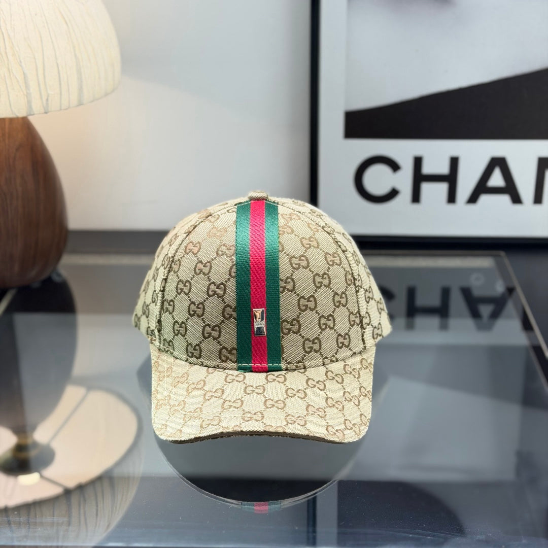 A beige monogram pattern baseball cap with a green and red central stripe and adjustable leather str