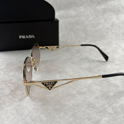 A pair of stylish geometric sunglasses featuring thin gold metal frames and tinted lenses.