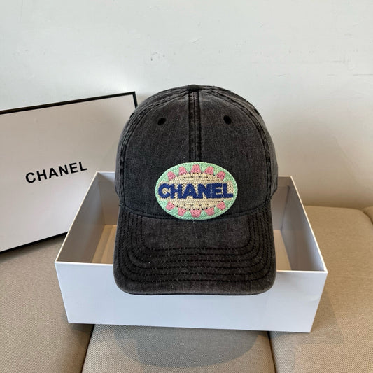 Black vintage-washed denim baseball cap featuring a colorful embroidered circular front patch.