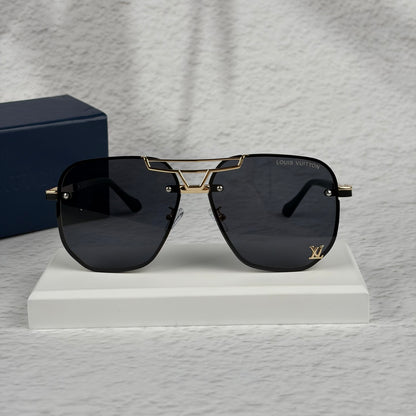 Modern aviator sunglasses with gold metal bridge, dark lenses, and black temple tips on display.