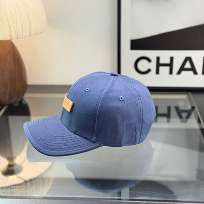 A navy blue cotton baseball cap with a rectangular tan leather-style patch on the front panel.
