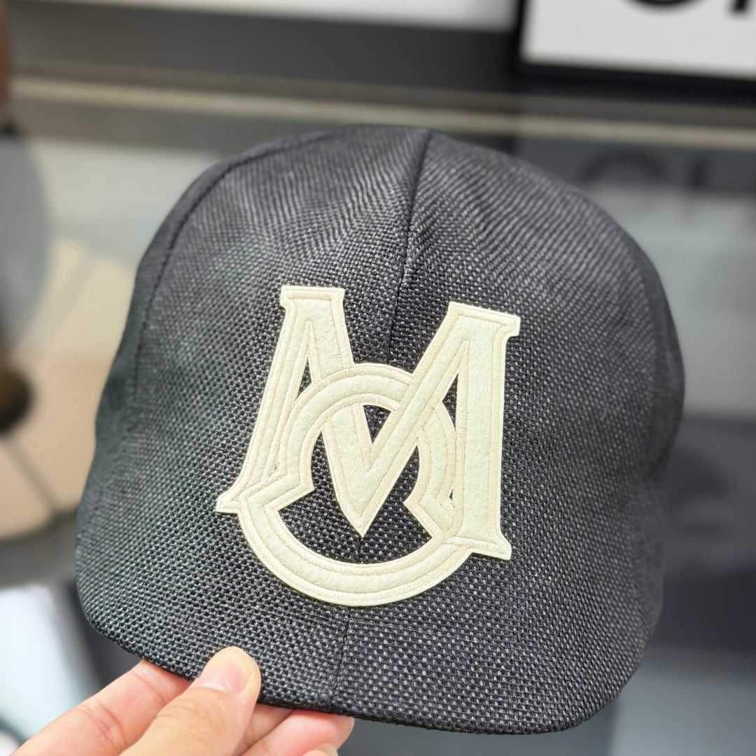 Close-up of a premium dark grey textured ivy cap with a white embroidered logo, high-quality fabric.