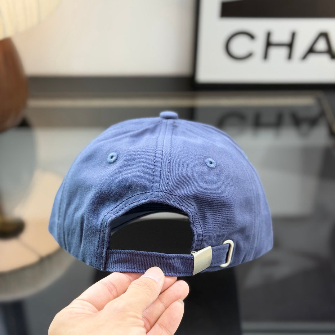 A navy blue cotton baseball cap with a rectangular tan leather-style patch on the front panel.