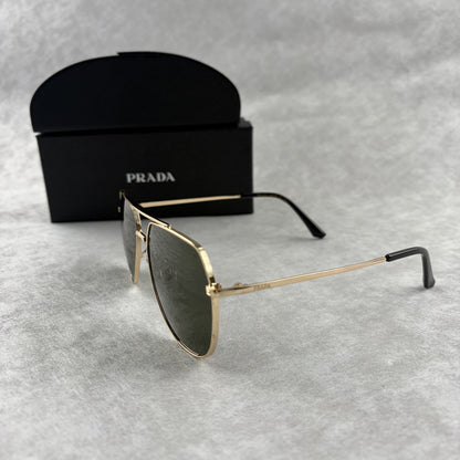 Classic gold-tone metal aviator sunglasses with tinted lenses, resting next to a protective case.