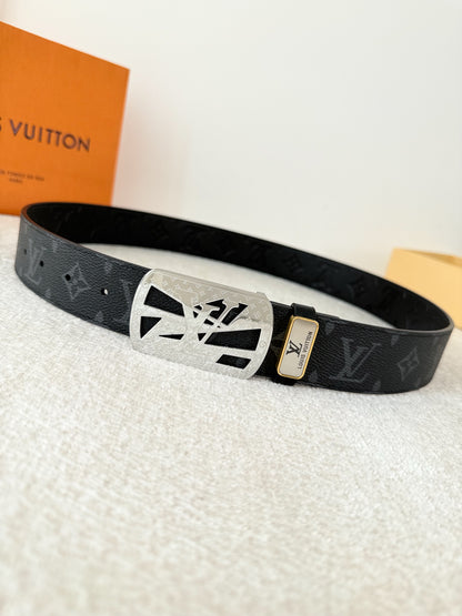A black leather belt with monogram pattern and an intricate silver-tone buckle, 3.8cm wide.