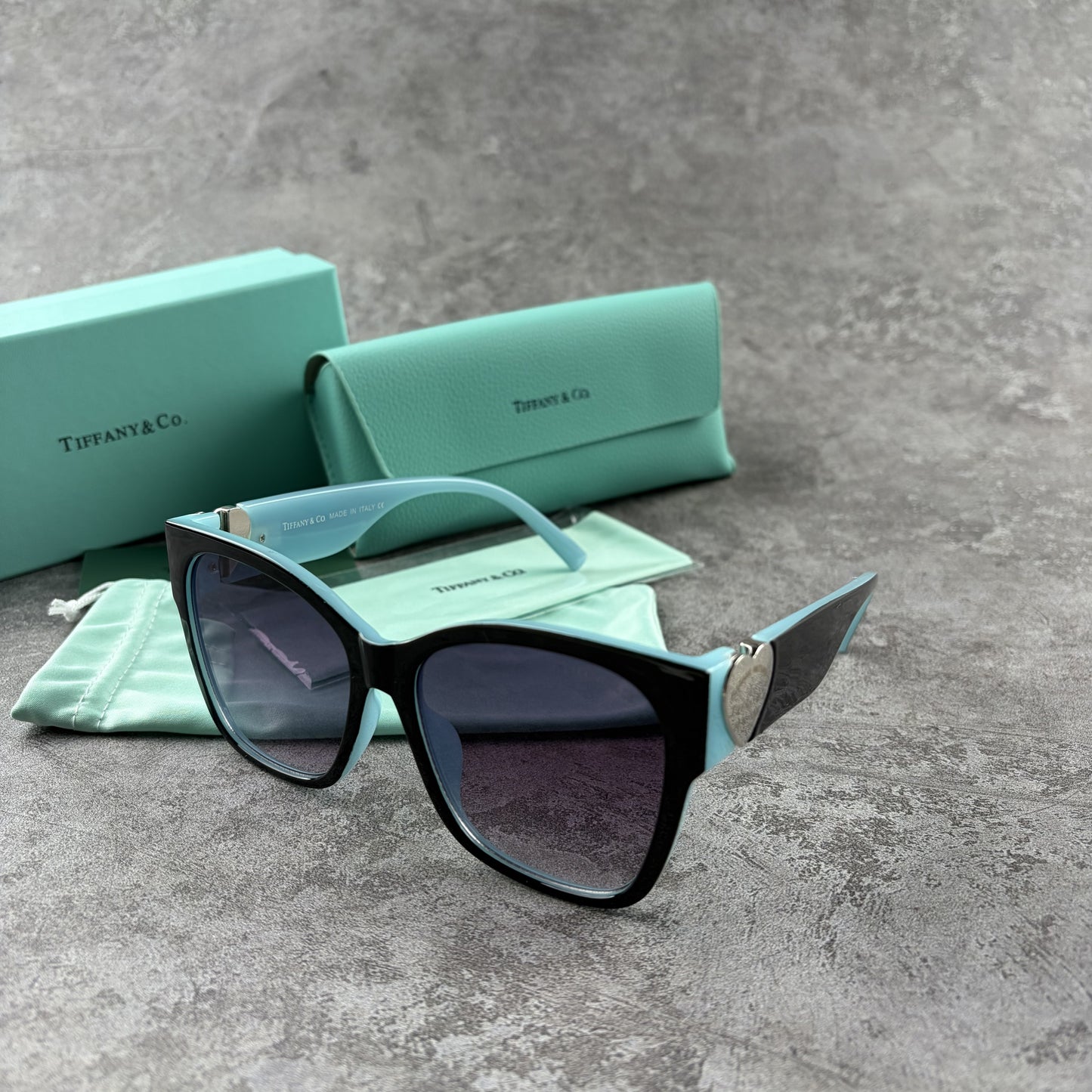 Stylish cat-eye sunglasses with gradient lenses and heart-shaped silver side details.