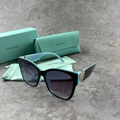 Stylish cat-eye sunglasses with gradient lenses and heart-shaped silver side details.