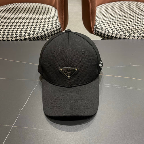 A black premium structured baseball cap with a centered metal triangular emblem on the front.