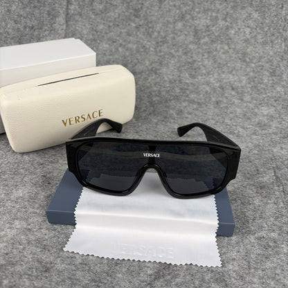 Oversized black shield sunglasses with a clean, modern aesthetic and protective hard storage case.